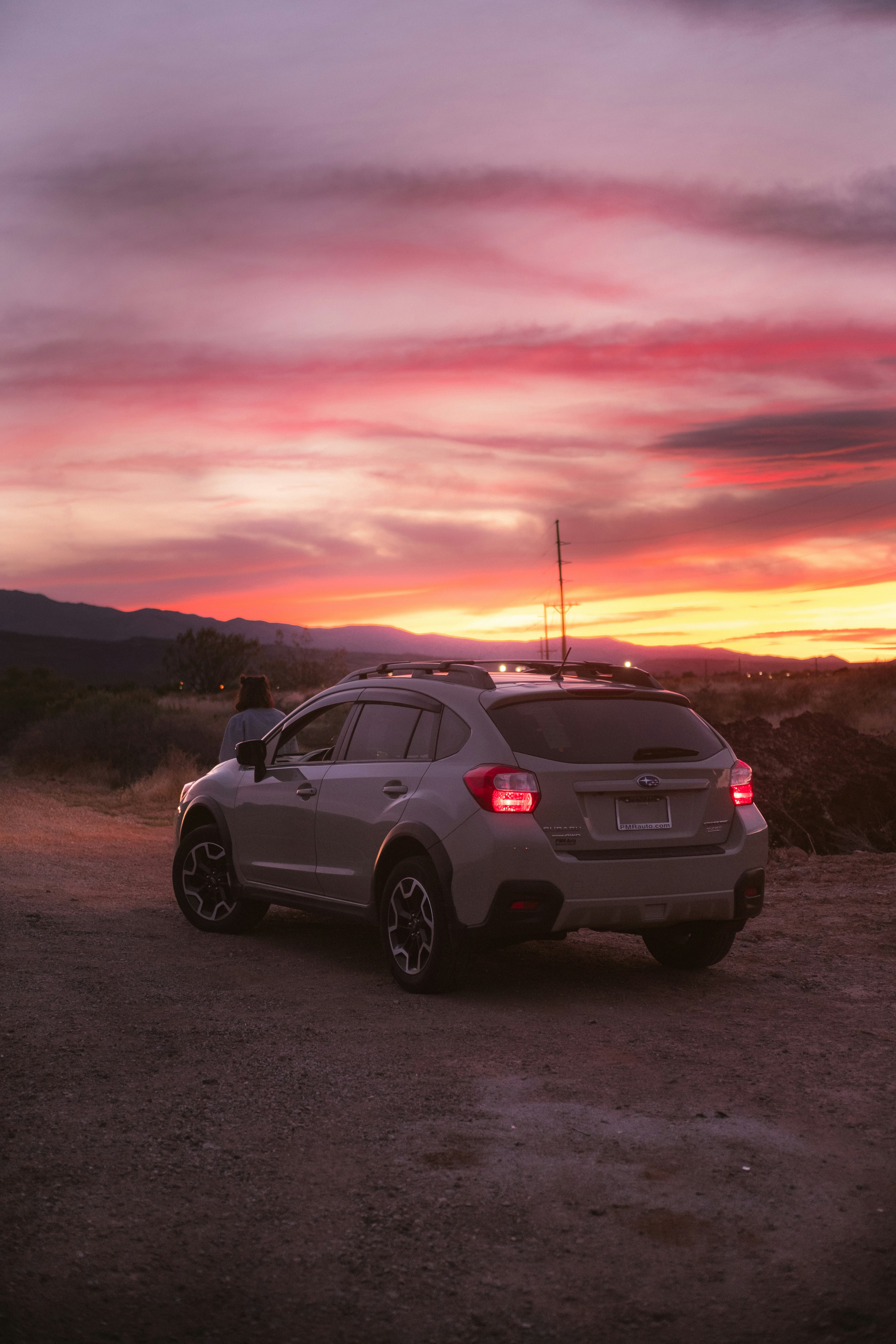 white suv on gray asphalt road during sunset